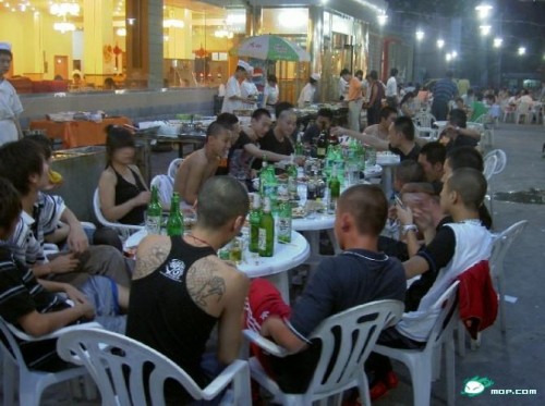 Chinese gang/black society/triad drinking beer outside.