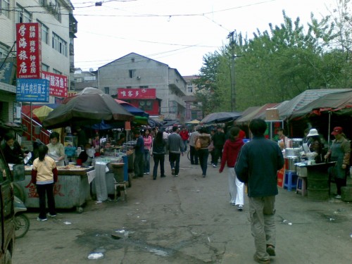 A food street with various vendors, hawkers, and peddlers in Wuhan, China.