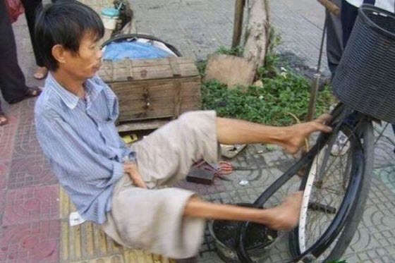 Photographs of a disabled & handicapped man with no hands in China making a 