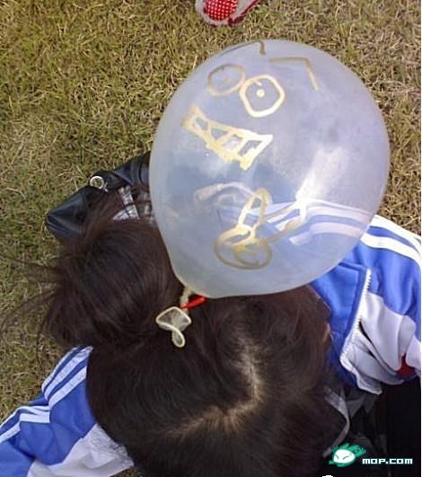 Chinese schoolgirl wears condom balloon with face drawn on it at school