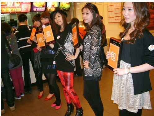 The young girls line up for photos displaying their advertisement.