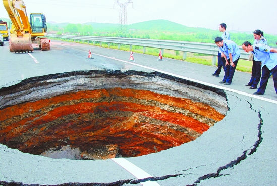 A sinkhole in the middle of a road in China.