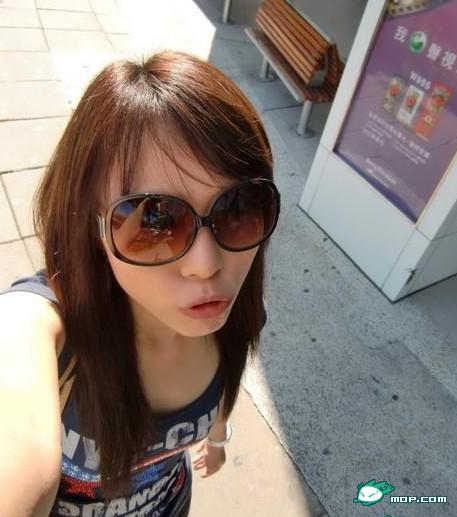 Chinese girl wearing sunglasses pouting her lips for the camera.