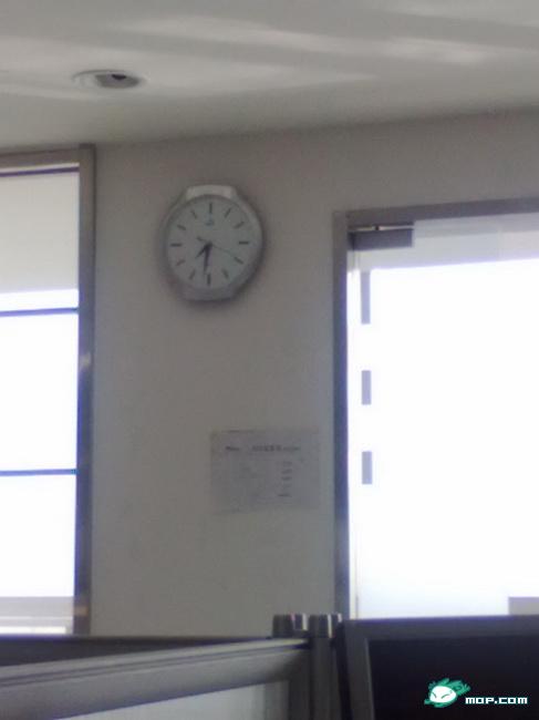 A clock hangs on the wall of an office.