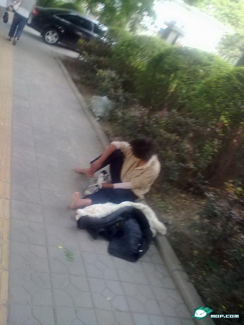 A homeless man on the sidewalk.