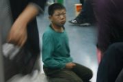 A child begger on the Beijing subway lines that does many inappropriate things to beg for money.
