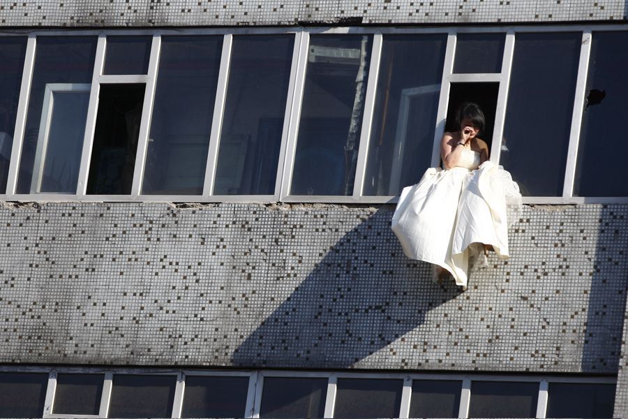 jumped off building. Woman wearing wedding dress jumps off building in Changchun,