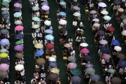 Parents and students under umbrellas in the rain in Guangdong, China.