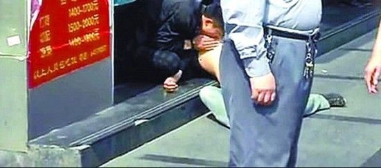 In Shanghai, a man sucks on the naked breast of a woman in broad daylight on a public street.